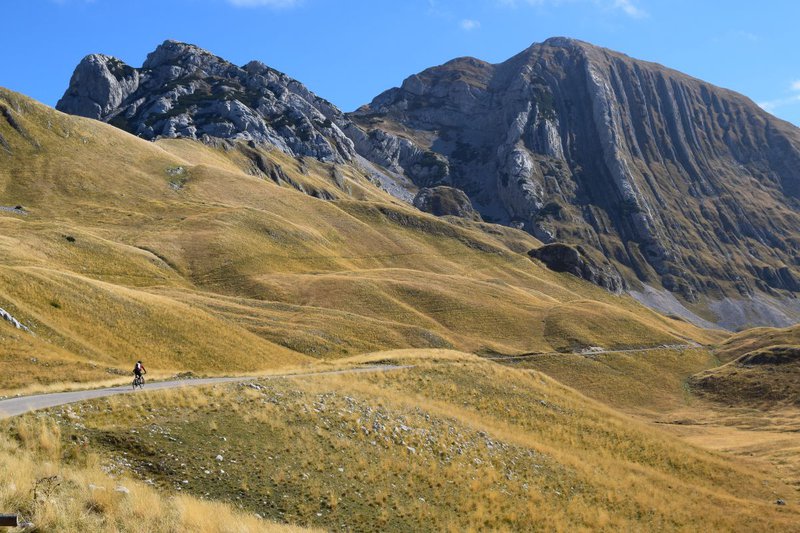 shutterstock_Bike-traveller-rides-on-a-road-in-the-mountains.jpg